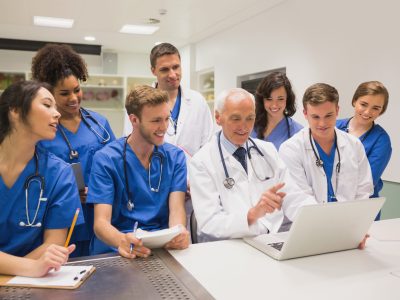 Medical,Students,And,Professor,Using,Laptop,At,The,University